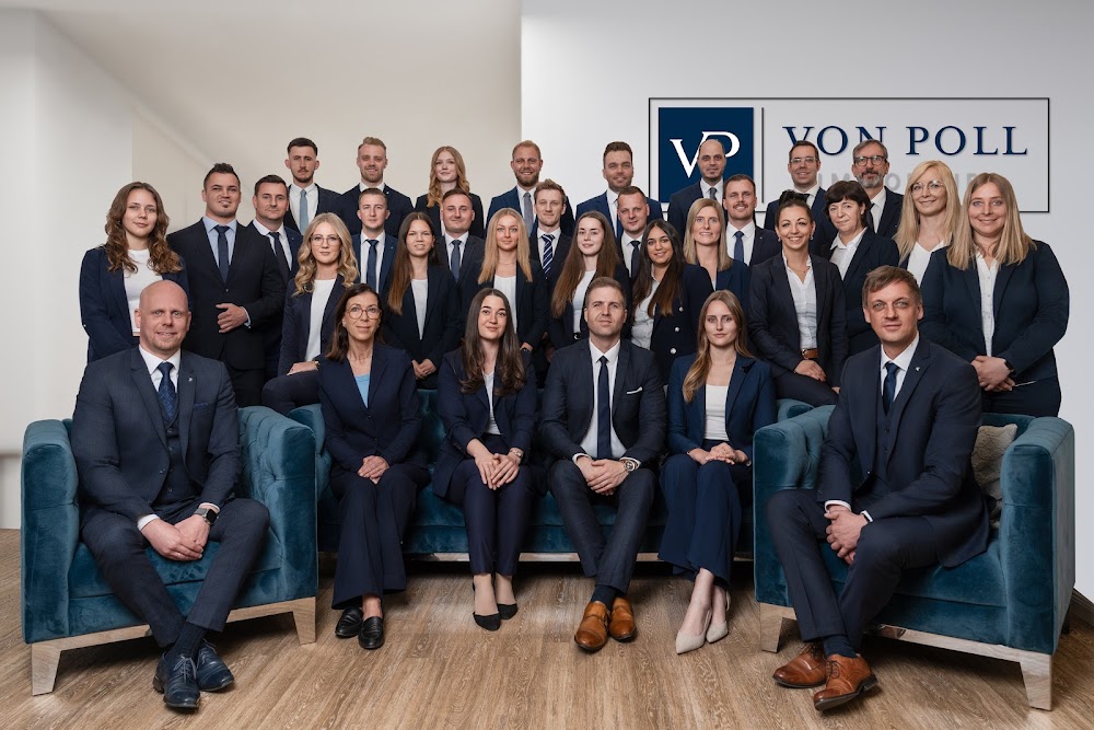 image of von poll team wearing same colour suit looking into camera ans smilling