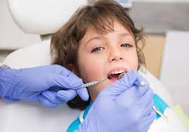 image of a kid getting his teeth check